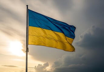 A vibrant Ukrainian flag billows proudly against a dramatic sky at sunset, showcasing the nation's colors of blue and gold.