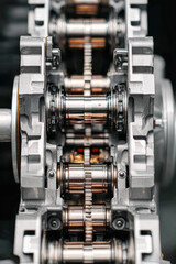 Obraz premium A close-up view of a mechanical engine component showcasing intricate gears and metallic details, emphasizing precision engineering and design.