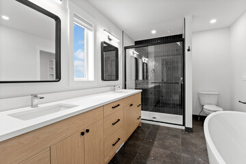 Bathroom with a large mirror and a black shower stall