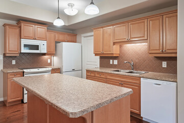 Kitchen with a white dishwasher and a granite countertop