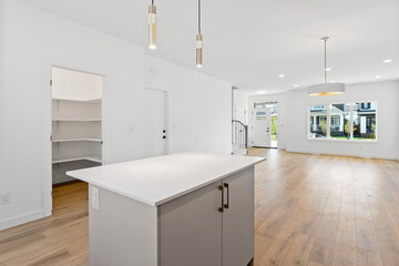 Kitchen with a white island and a white refrigerator