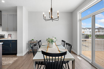 Large chandelier hangs above a dining table with a white tablecloth