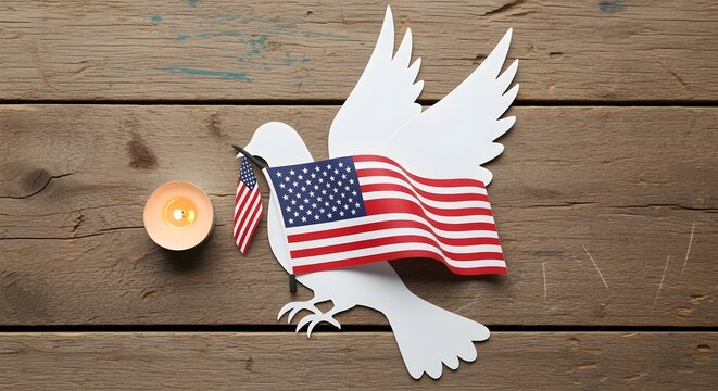 Flat lay of white dove cutout with U.S. flag and candle on rustic background.