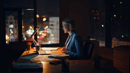 Employee greeting virtual conference gesturing to laptop camera in night home