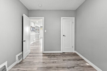 Room with a white door and a gray wall