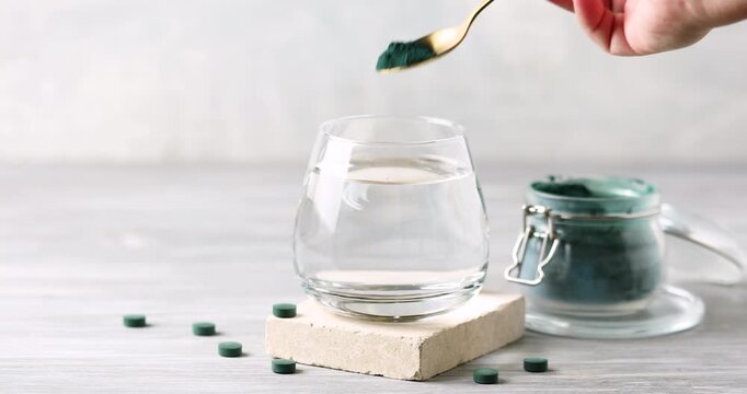 Spirulina algae powder dissolved in water in a glass