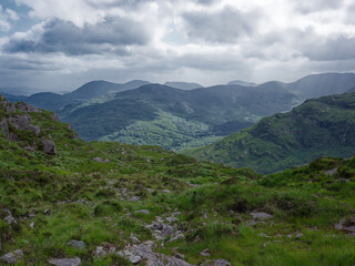 Breathtaking panoramic view of Ireland&rsquo;s stunning countryside. Rolling green hills under a dramatic sky create a sense of tranquility.