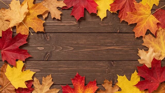  Falling autumn leaves frame on wooden table top view