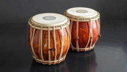 Two traditional drums on dark surface