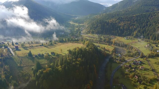 Breathtaking bird's eye view of the serene Prut River valley nestled between evergreen mountain slopes. Carpathian mountains, Ukraine.
