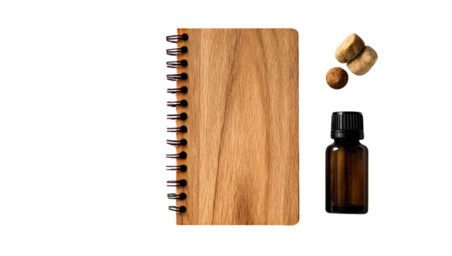Wooden spiral-bound notebook, small amber bottle, and two wood corks
