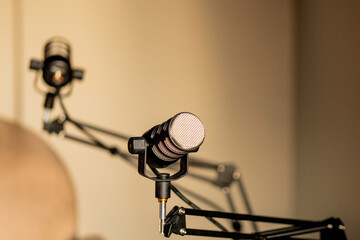 Podcast setup featuring microphones on adjustable arms in a modern studio environment, ready for recording engaging discussions and interviews