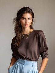 Obraz premium Portrait of a Young Woman with Brown Top and Light Blue Pants
