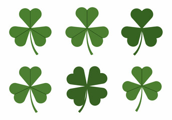 Collection of green clover leaves, including shamrocks and a lucky four-leaf clover, isolated on white background.