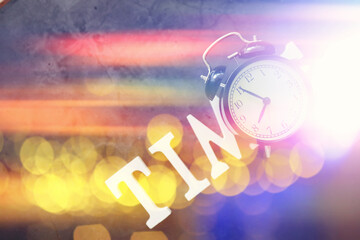 Background with a clock on the table and bokeh in pastel rainbow colors. Time for rest and travel.