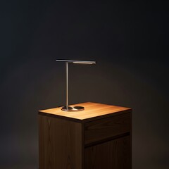 Sleek, modern desk lamp sits atop a warm, natural wood nightstand, bathed in soft, focused light.