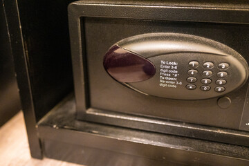 Black safe box or modern electronic locker in hotel room or home.