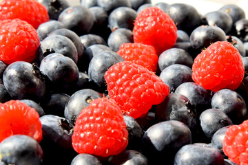 Close-up background image of blueberries and raspberries
