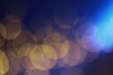 Abstract bokeh background. Golden bokeh circles on dark blue background. Layer overlay.