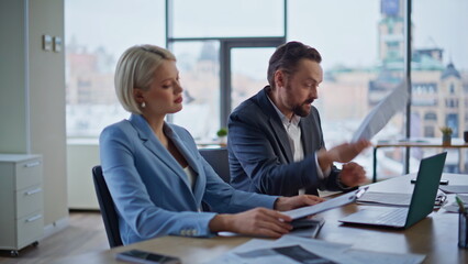 Business partners arguing video call holding financial report at office closeup