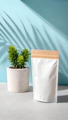 A white stand up pouch with a kraft top is shown next to a green plant, with leaf shadows cast on a blue background.