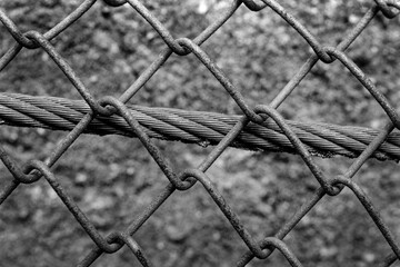 Closeup of an old chain fence. Captured on a B&W film. Vintage style.