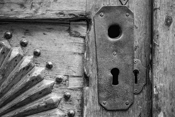 Keyhole. Detail of ancient door captured on a B&W film. Vintage style.