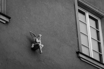Angel on a wall. Architectural detail captured on a B&W film. Vintage style. In Poznan, Poland.