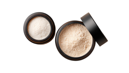 Two round, open cosmetic powder jars.  Light tan/beige powder fills each jar.  Black lids.  High angle, studio shot