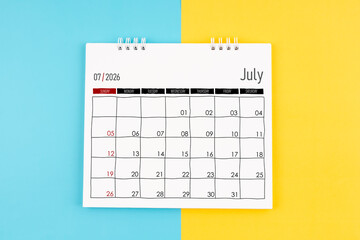 July 2026 calendar on blue and yellow color background, Flat lay.