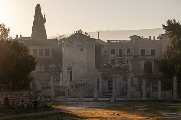 Naklejka premium Athens, Greece. Tower of the Winds, an octagonal Pentelic marble horologion built in the 1st century BC by Andronicus of Cyrrhus, illuminated at sunrise in the Roman Agora