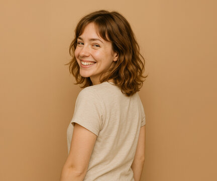 Natural portrait of a cheerful woman looking back on a forest path