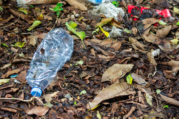 Plastic trash, PET bottle and plastic bag in the forrest. The environmental pollution. Nature protection.