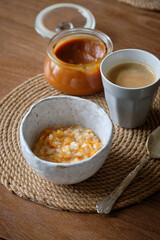 Autumn comfort breakfast food, pumpkin rice porridge with cinnamon and spices, Sweet pumpkin rice pudding with honey for fall brunch