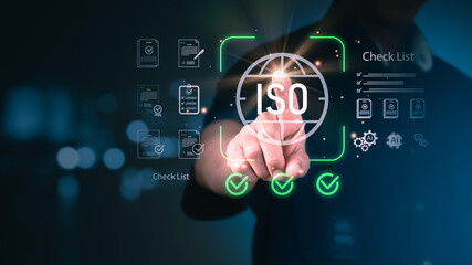 A professional hand interacts with a futuristic digital interface displaying the ISO symbol and checkmarks, representing quality management, certification, compliance, and business excellence.