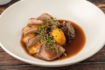 Sliced pan-seared duck breast with crispy skin and rich brown sauce