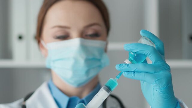A laboratory technician meticulously measures and prepares blue liquid solutions, showcasing precision in scientific research and analysis. The atmosphere highlights a focus on chemistry. - Powered by Adobe