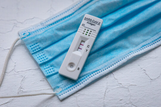 SARS-CoV-2 rapid antigen test with two colored lines - positive result of coronavirus infection