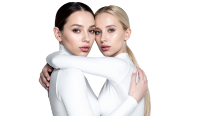 Two beautiful women embracing each other, showcasing a bond of sisterhood and support. Their matching outfits add to the sense of unity and connection