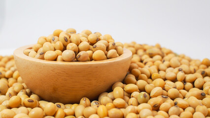 Raw Soybeans in Wooden Bowl on Pile of Soybeans Background