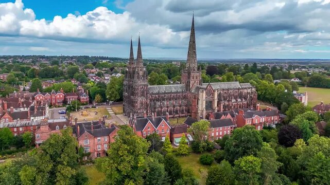 A full semicircle rotating aerial view around the cathedral in the town of Lichfield, UK in summertime