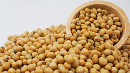Close-up of soybeans spilling from a wooden bowl
