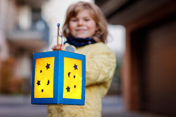 Little Preschool Kid Girl Holding Selfmade Traditional Lanterns with Candle for St. Martin Procession. Child Happy about Children and Family Parade in Kindergarten. German Tradition Martinsumzug. © Irina Schmidt