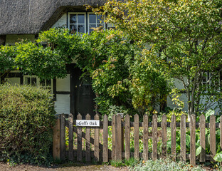 Traditional English village with thatched cottages.