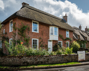 Traditional English village with thatched cottages.