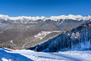 A beautiful winter landscape with a mountain resort and snow on the slopes.