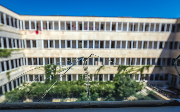 Broken window Pelegrin Hotel in so called Bay of Abandoned Hotels in Kupari, Croatia