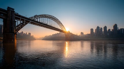 Obraz premium Modern city skyline with bridge over river at sunset, golden reflection on water, urban architecture, transportation and cityscape background