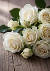 Obraz premium Elegant ivory roses arranged on rustic weathered wooden planks surface