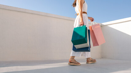 Woman carrying shopping bags on a sunny day